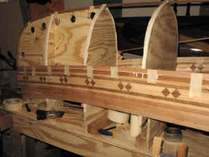 I'm a big fan of using 1.5" masking tape to hold strips together until the glue holds.